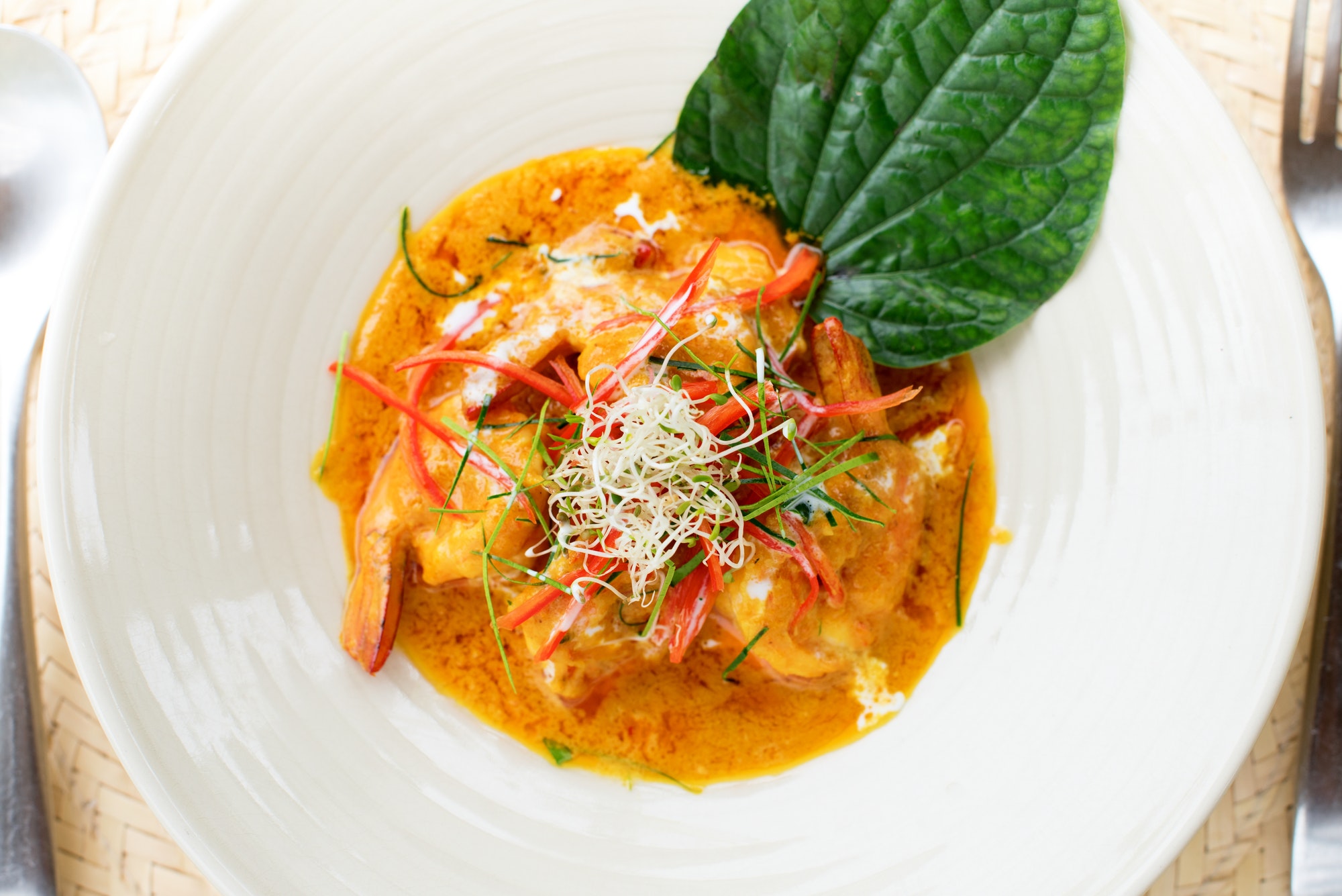 Shrimp in red curry paste with coconut milk kaffir lime leaves Thai traditional cuisine Restaurant